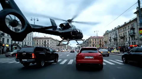 Вертолёт вошёл в кадр над проспектом, машины под ним. Три уровня действия одновременно: земля, воздух, глубина улицы.